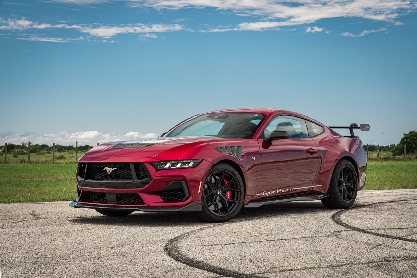 Red Hennessey Super Venom 850 supercharged Ford Mustang GT with carbon fiber wing