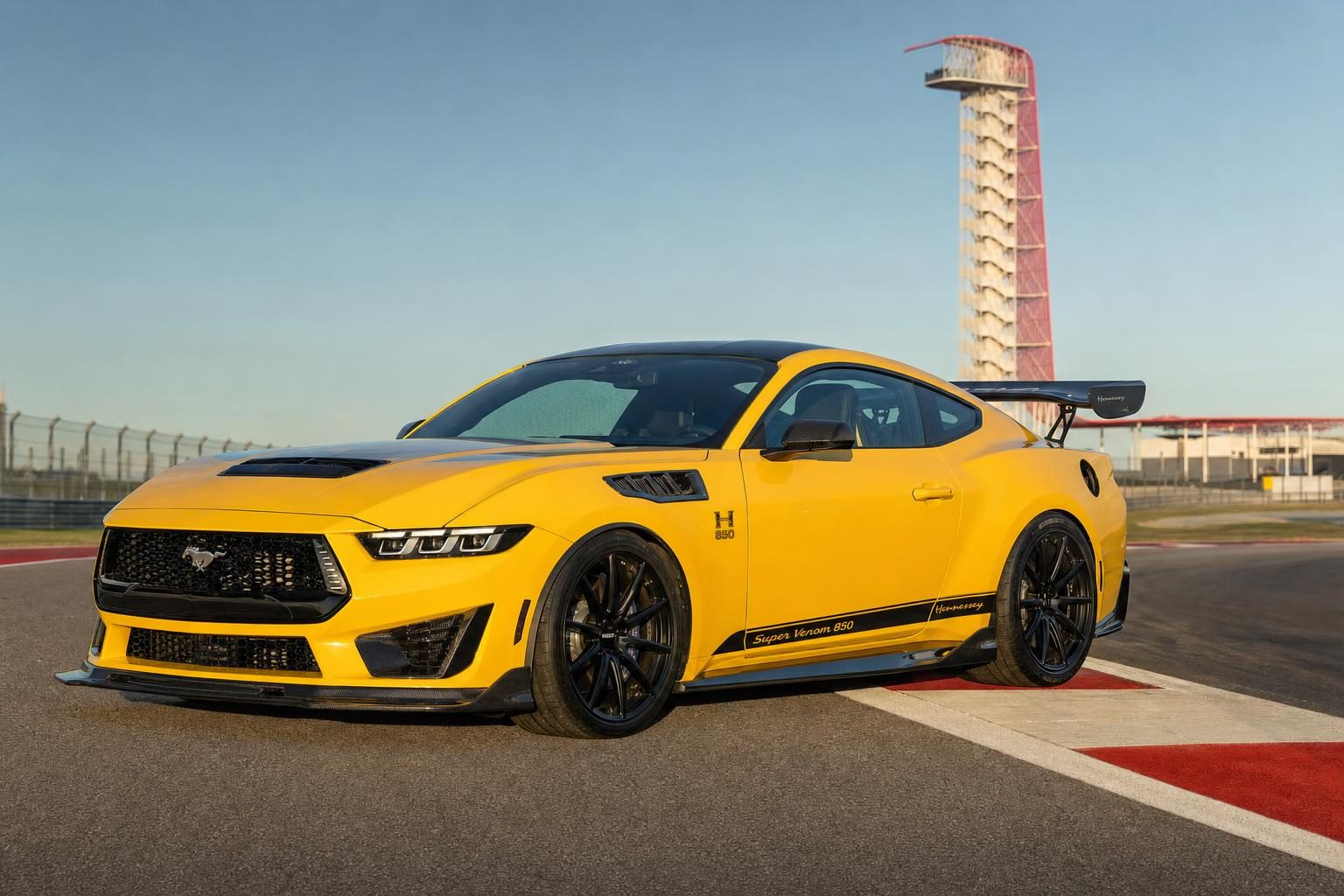 Yellow Hennessey Super Venom 850 Ford Mustang GT with carbon fiber gooseneck wing on track at Circuit of The Americas in Austin