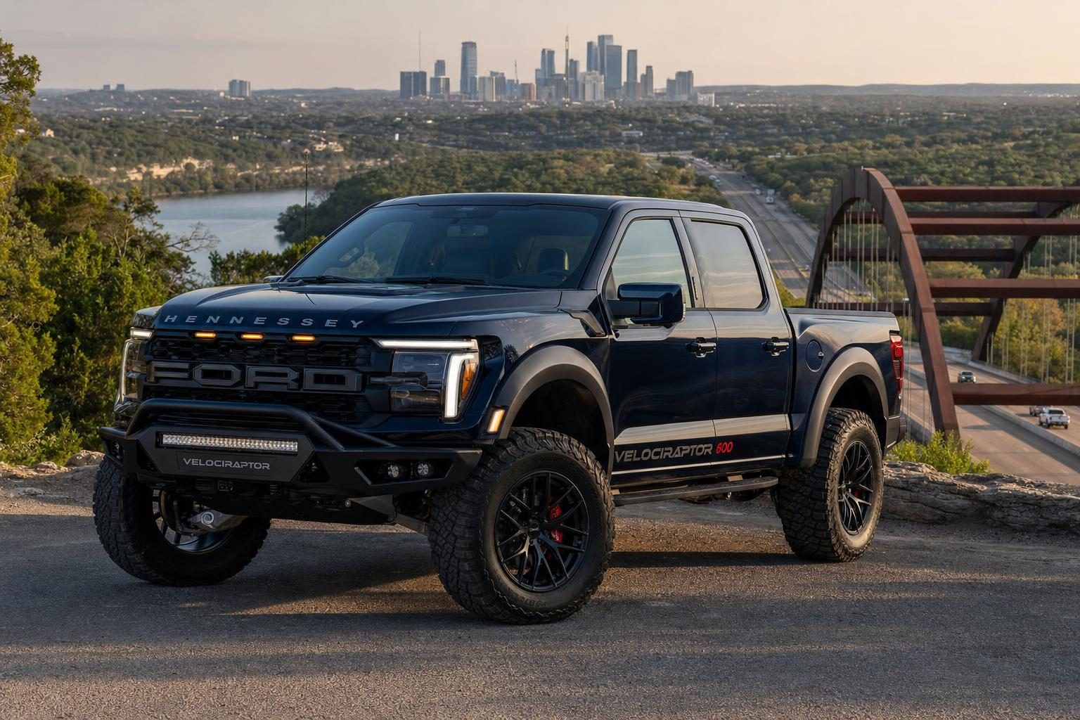 Hennessey VelociRaptor 600 Ford F-150 Raptor in Antimatter Blue parked above the Pennybacker 360 Bridge with the Austin skyline behind
