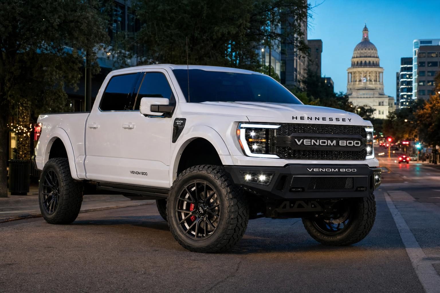 White Hennessey Venom 800 lifted Ford F-150 on South Congress Avenue in Austin with the Texas State Capitol at dusk